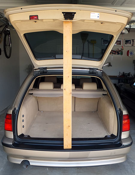 Tailgate propped open with 2x4 lumber